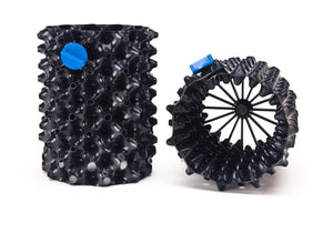 Two black, cylindrical Air-Pot propagation cells with a textured, dimpled design and blue fixing screws on white.