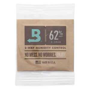 Boveda 62% humidity control packet in a small brown paper pouch for moisture regulation, shown inside clear packaging.