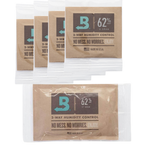 Four small and one large Boveda 62% humidity control packets in brown paper pouches, used for storage and preservation.