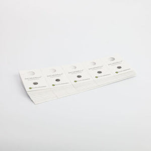 A stack of white cardboard release cards featuring Encarsia formosa parasites for biological whitefly control.
