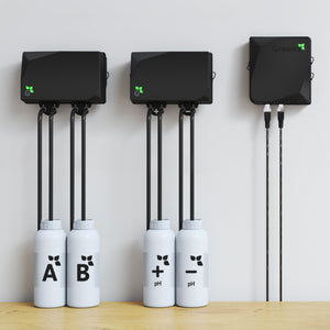 Growee Starter Combo Doser: black wall-mounted control units connected to four labeled nutrient/pH bottles for hydroponics.