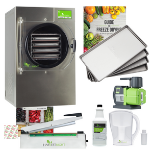 Harvest Right stainless steel small freeze dryer with four trays, vacuum pump, Mylar bag sealer, and food storage kit.