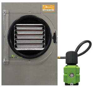 Stainless steel Harvest Right pharmaceutical freeze dryer with internal trays and a green vacuum pump attached.