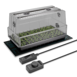 Clear, tall seedling dome with built-in LED lights, black tray, heat mat, and digital controllers for plant propagation.