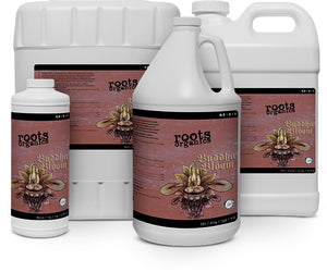 Various white plastic jugs of Roots Organics Buddha Bloom liquid plant fertilizer featuring brown lotus flower labels.