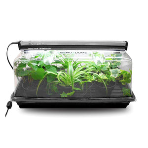 SunBlaster mini greenhouse kit with a clear plastic dome, black tray, and T5 grow light over small potted plants.
