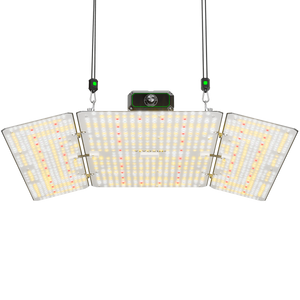 Hinged LED grow light with three rectangular panels showing white, yellow, and red diodes, suspended on black ropes against black.