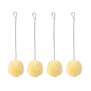 Four yellow fuzzy wool dryer balls with wire stems and hanging loops on white.