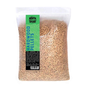 Clear plastic bag of brown hardwood sawdust pellets with green and blue North Spore label.