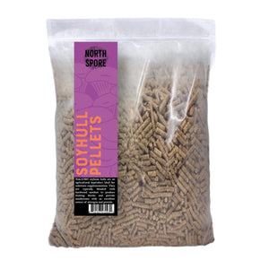 Clear plastic bag filled with brown soy hull pellets, featuring a purple label with orange and black text.