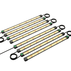 Eight long, narrow LED grow light bars with warm light and black ends, arranged diagonally on a black background.