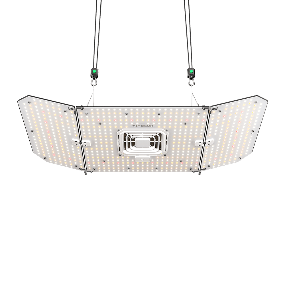 Black grow light with three panels covered in small LEDs, hanging by black ropes against a solid black background.