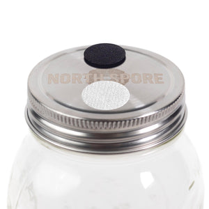A glass mason jar with a silver lid featuring a black filter patch and a white self-healing injection port.