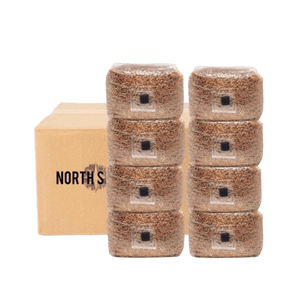 Two stacks of four brown mushroom grain bags in front of a cardboard shipping box.