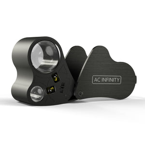 Black metal jeweler's loupe with LED lights, magnifying lens, and swinging protective cover featuring AC Infinity logo.