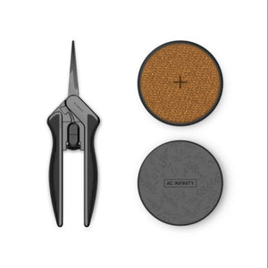 Black pruning shears next to a round cork pad and a circular grey base with the AC Infinity logo.
