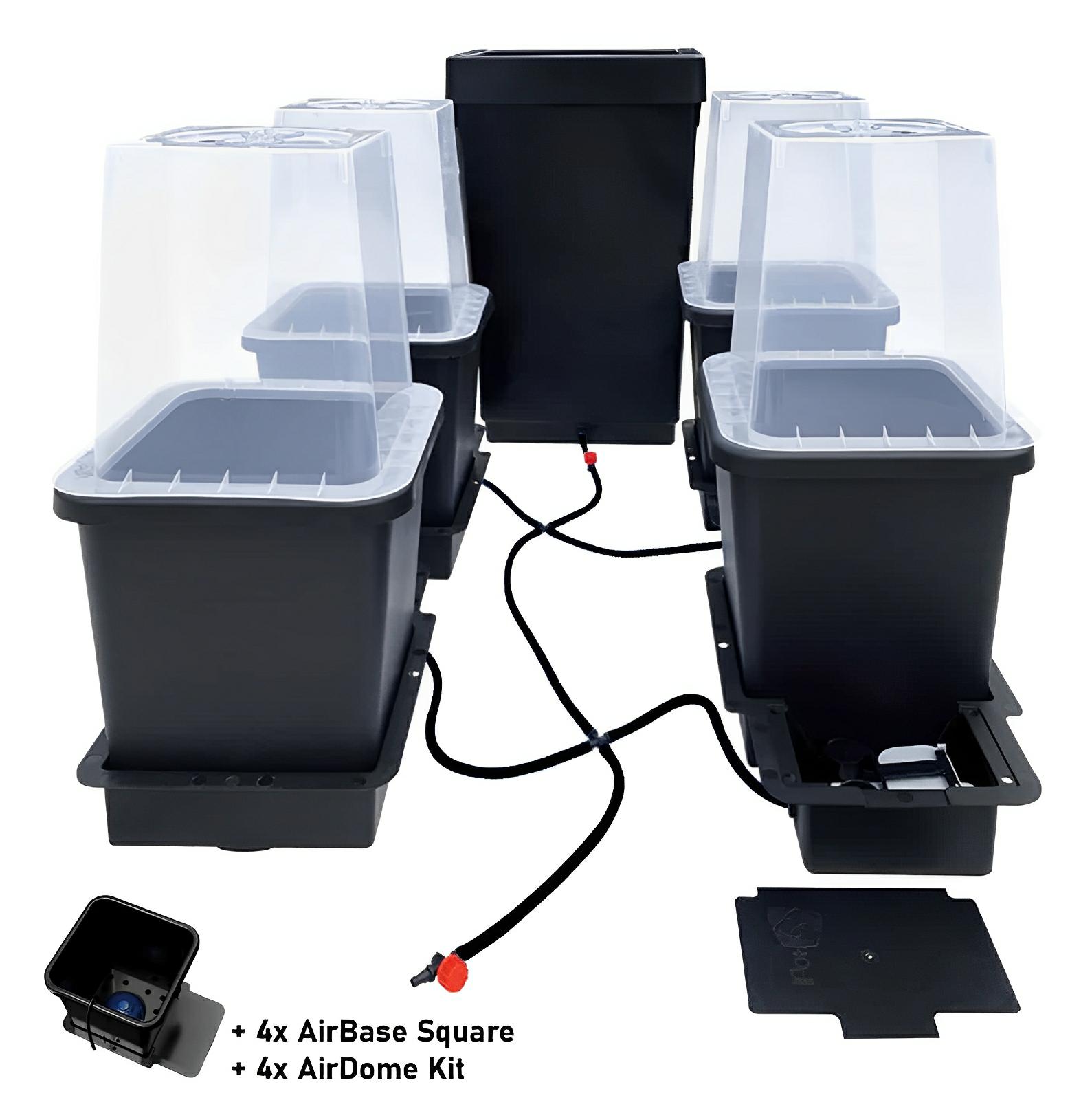 AutoPot 4-pot self-watering system with black plastic pots, clear covers, a reservoir, and tubing for hydroponic gardening.