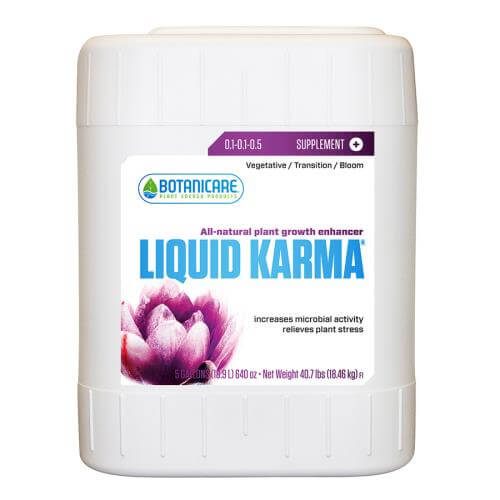Five-gallon white plastic jug of Botanicare Liquid Karma plant growth enhancer with a purple flower on the label.