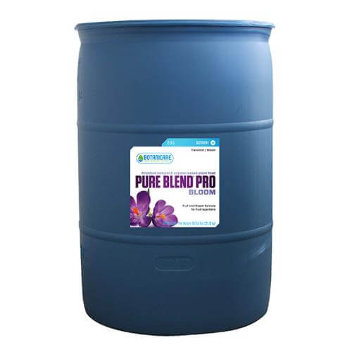 Large blue 55-gallon barrel of Botanicare Pure Blend Pro Bloom plant nutrient with flower graphic on white label.