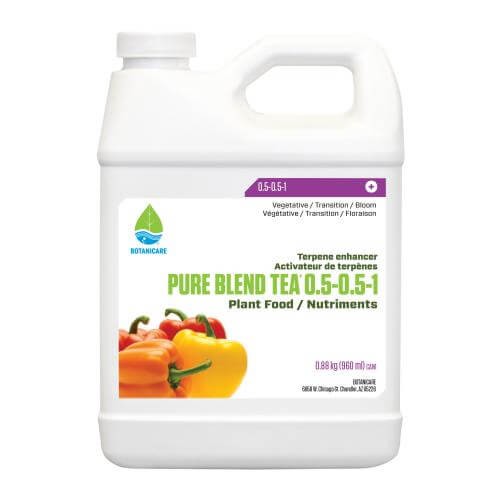 White gallon jug of Botanicare Pure Blend Tea plant food featuring a label with orange and yellow bell peppers.
