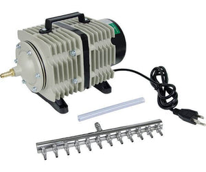 Gray industrial air pump with handle, power cord, tubing, and a 12-outlet metal manifold on a white background.
