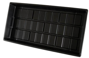 High-angle view of a rectangular, black plastic nursery seedling tray with a grid-patterned base.