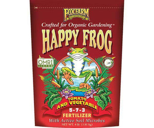 Red FoxFarm Happy Frog Tomato and Vegetable 5-7-3 fertilizer bag with organic gardening and OMRI listed labels.
