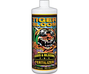 One quart white plastic bottle of Tiger Bloom 2-8-4 fertilizer featuring a tiger illustration and floral design.