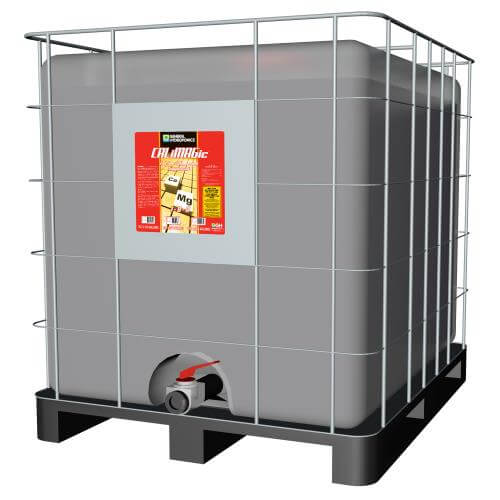 Large grey liquid tote in a metal cage on a black pallet with a red and orange Cal-Mag nutrient label.