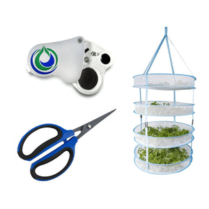 A jeweler’s loupe, blue-handled trimming scissors, and a four-tier hanging mesh herb drying rack with plant material.