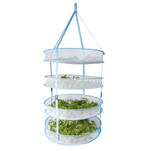 Four-tier hanging mesh drying rack in light blue, filled with green herbs, isolated on a white background.