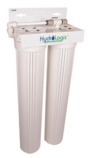 White, dual-canister HydroLogic water filtration system with top mounting bracket and plumbing connections.
