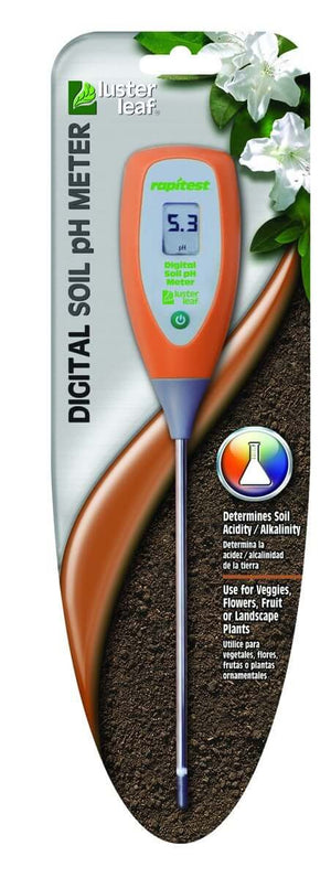 Orange handheld digital soil pH meter with metal probe in original packaging against a soil and flower background.