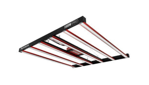 Low-angle shot of a Photontek X600W PRO LED grow light with six linear red and white bars on a black frame.